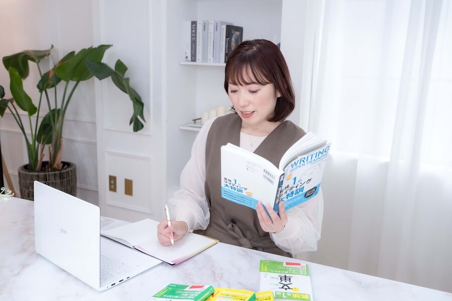 ノートパソコンを開き英語の勉強をしている講師 sacco